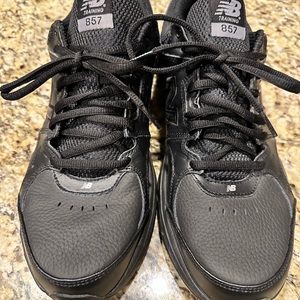 New Balance MX857BK black tennis shoes.